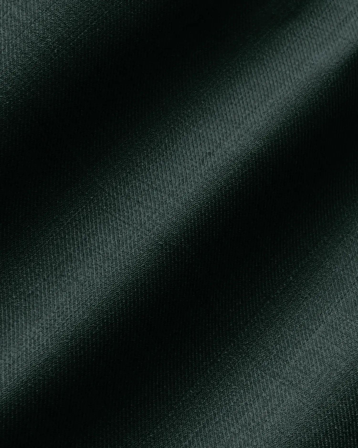 Dark green textured fabric with a diagonal shadow pattern creating an elegant and sophisticated appearance.