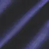 Close-up of dark blue textured fabric with diagonal light and shadow patterns.