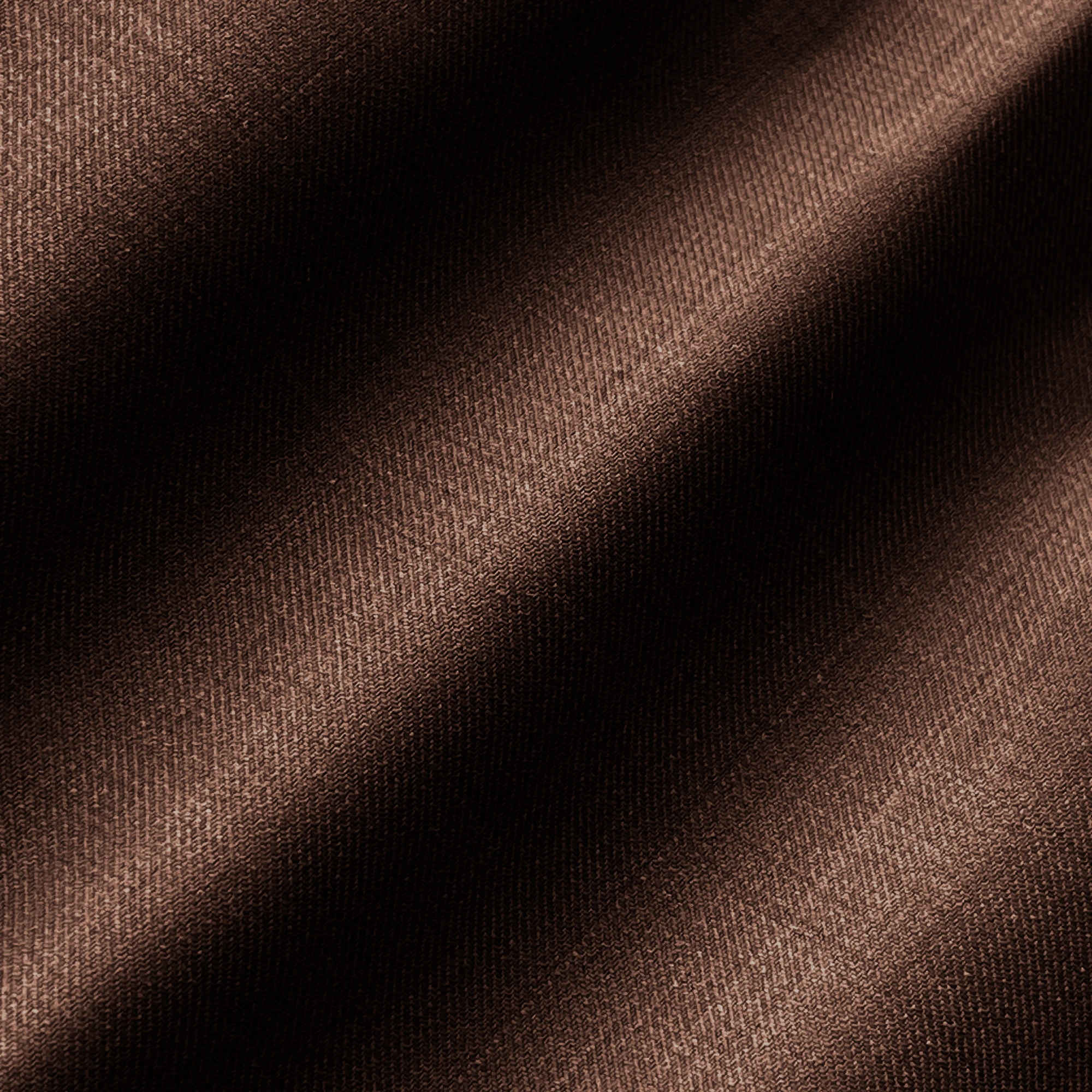 Brown fabric texture with soft, diagonal light and shadow, showcasing rich material details and wave patterns.