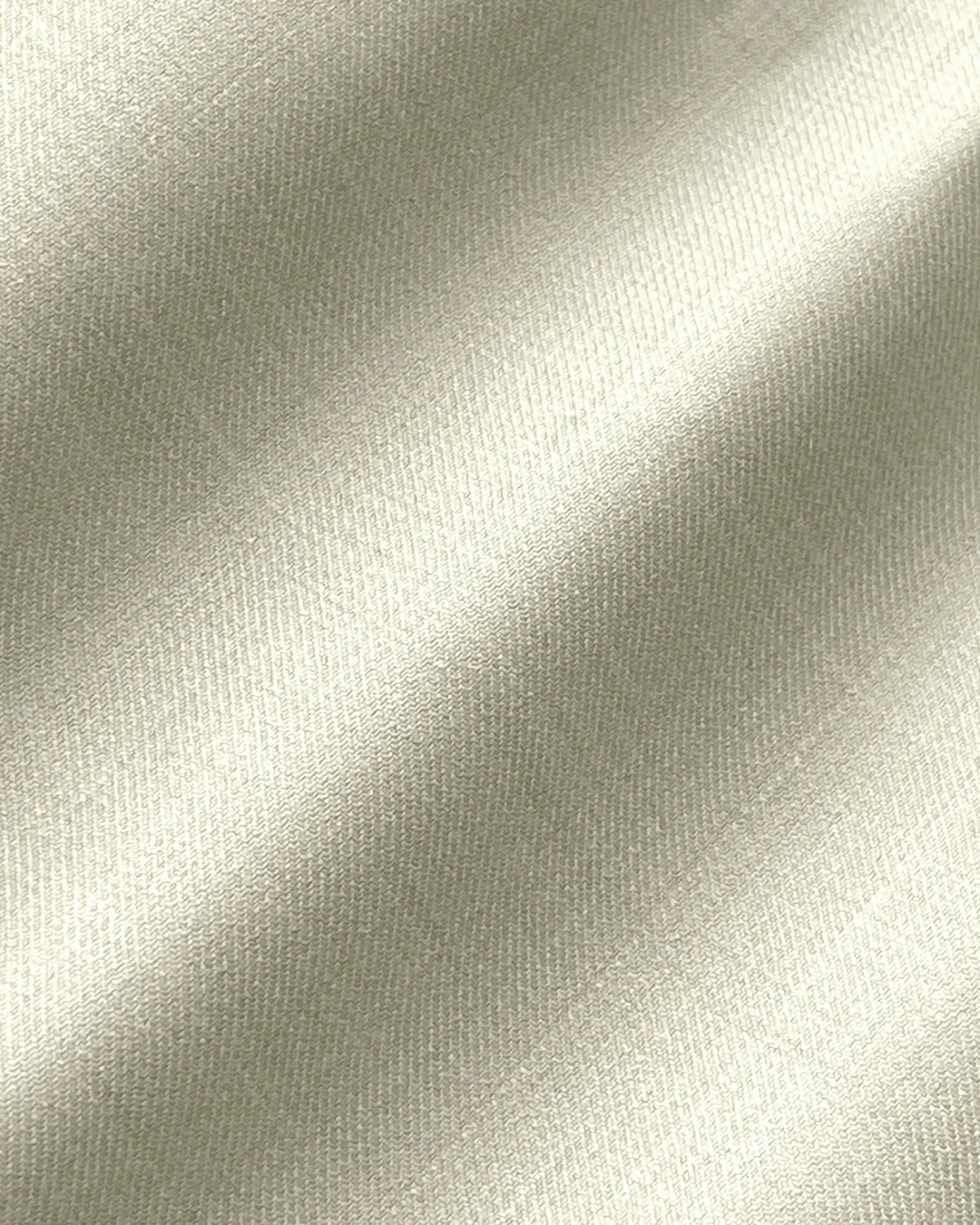 Smooth cream silk fabric close-up, showcasing soft texture and elegant sheen. Perfect for luxury apparel and decor.