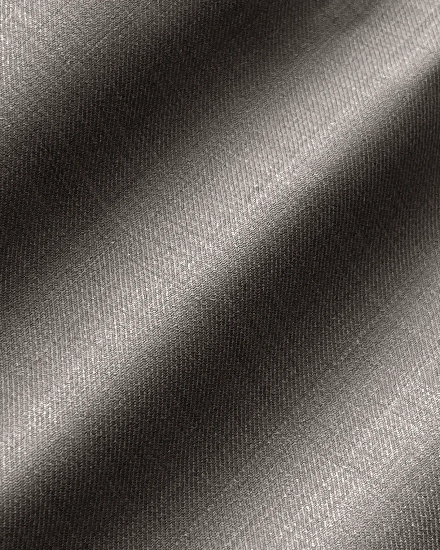 Close-up of gray textured fabric with diagonal lines, showing detailed weave pattern for design or textile use.