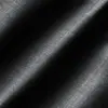 Close-up of black textile fabric texture with highlighted grooves, showcasing detailed weave pattern and shadow play.