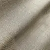 Close-up of textured beige fabric with intricate, wavy patterns creating a soft, rippled effect.