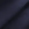 Close-up of dark blue fabric with a textured zigzag pattern, creating a wavy visual effect.