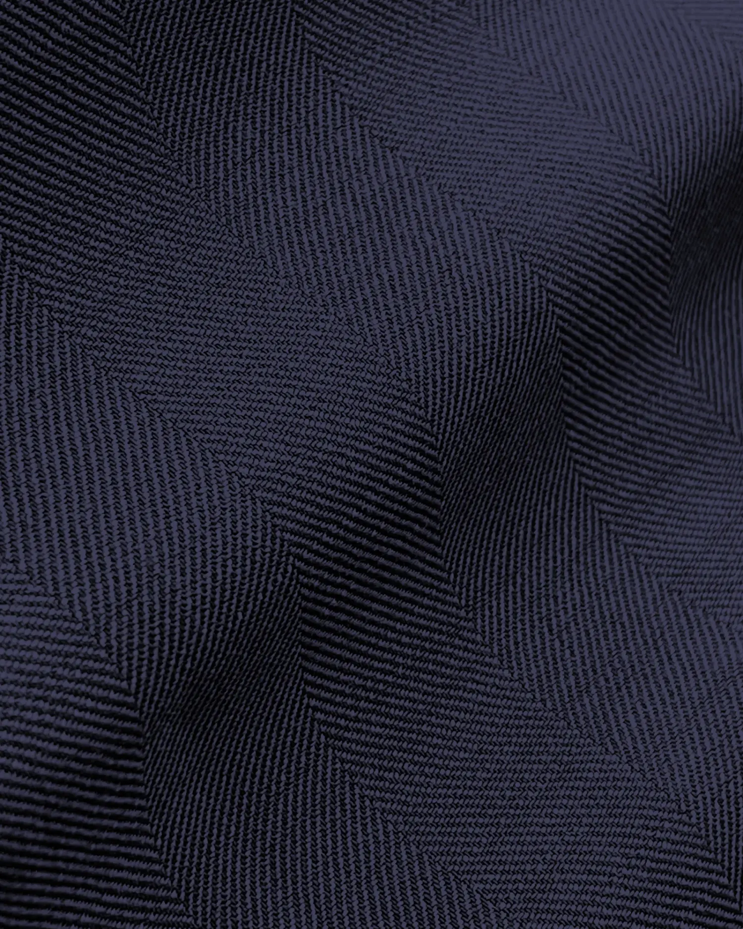 Close-up of dark blue fabric with a textured zigzag pattern, creating a wavy visual effect.