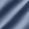 Close-up of blue denim fabric texture with diagonal weave pattern, showcasing clothing material details.