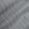 Close-up of gray fabric with subtle wavy stripes, showcasing texture and pattern, ideal for fashion or home decor.