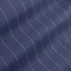 Close-up of dark blue wavy pinstripe fabric with light grey lines, showcasing texture and pattern.