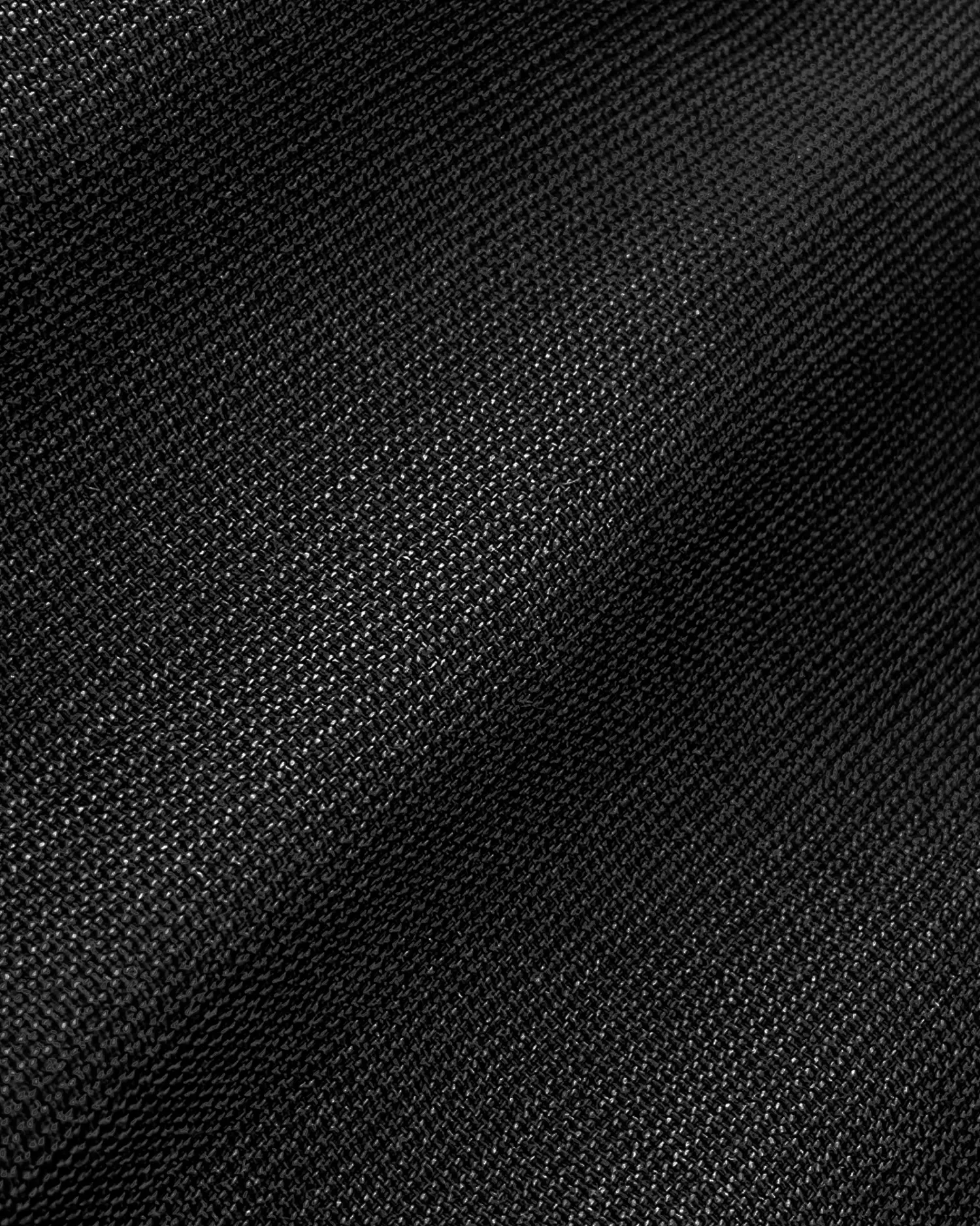 Close-up of textured black fabric with visible weave pattern for textiles and design.