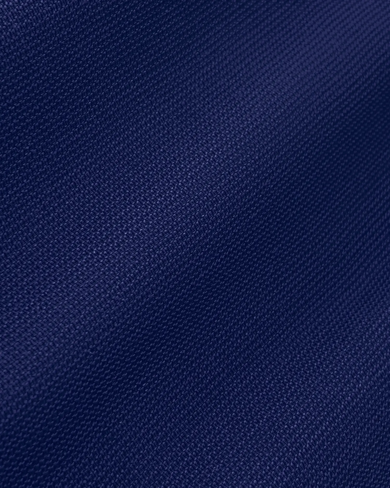 Close-up of blue textured fabric with subtle waves, perfect for upholstery or fashion design projects.