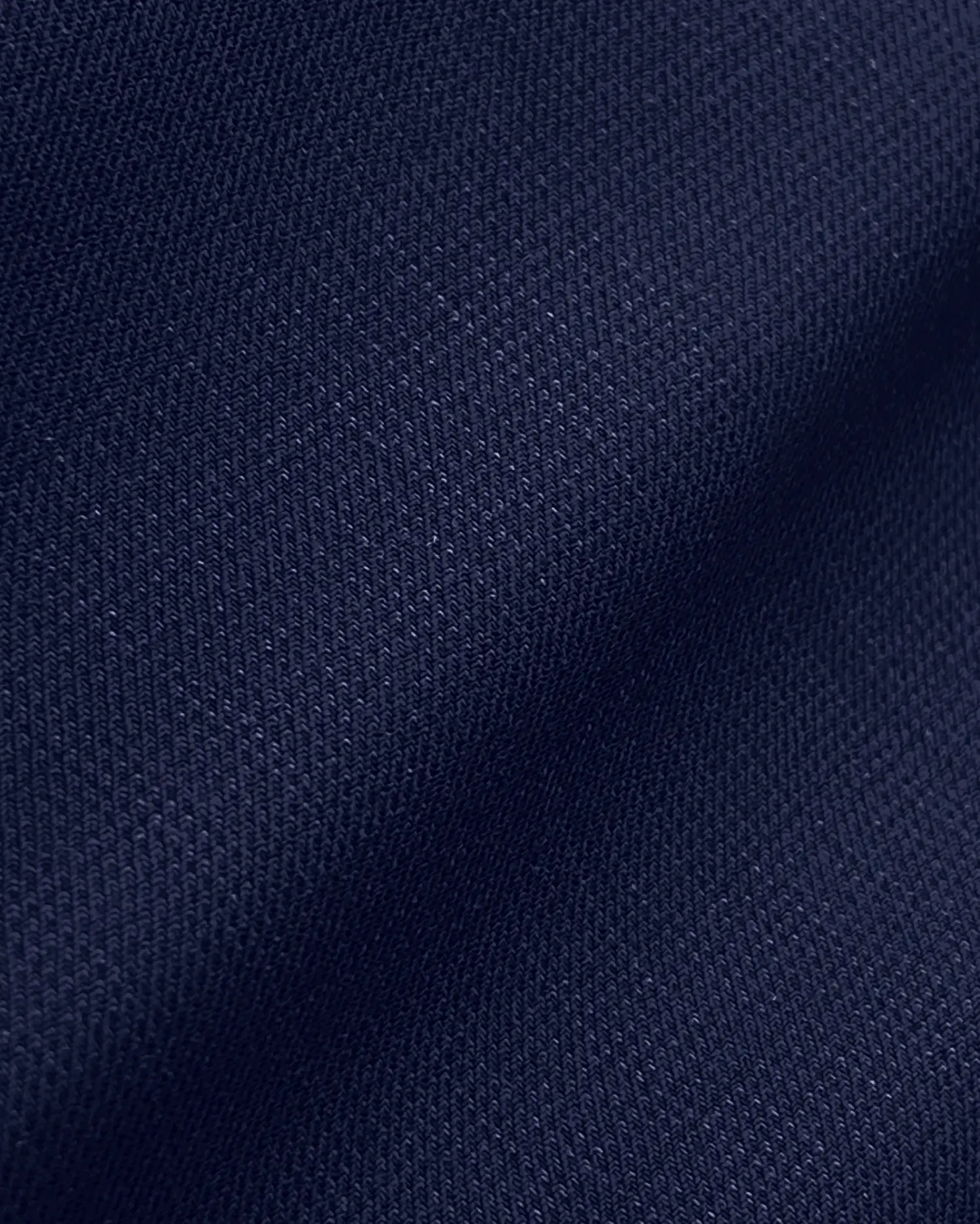 Close-up of navy blue fabric texture with detailed weave pattern. Ideal for fashion and textile design visuals.