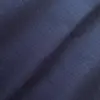 Close-up of dark blue herringbone fabric texture with a subtle chevron pattern, showcasing intricate textile details.