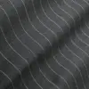 Wavy gray fabric with dotted lines creating a textured pattern.