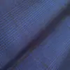 Close-up of blue and dark textured plaid fabric pattern, highlighting detailed weave and intricate design.