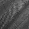 Gray herringbone textured fabric close-up, showcasing intricate pattern detail and woven texture.