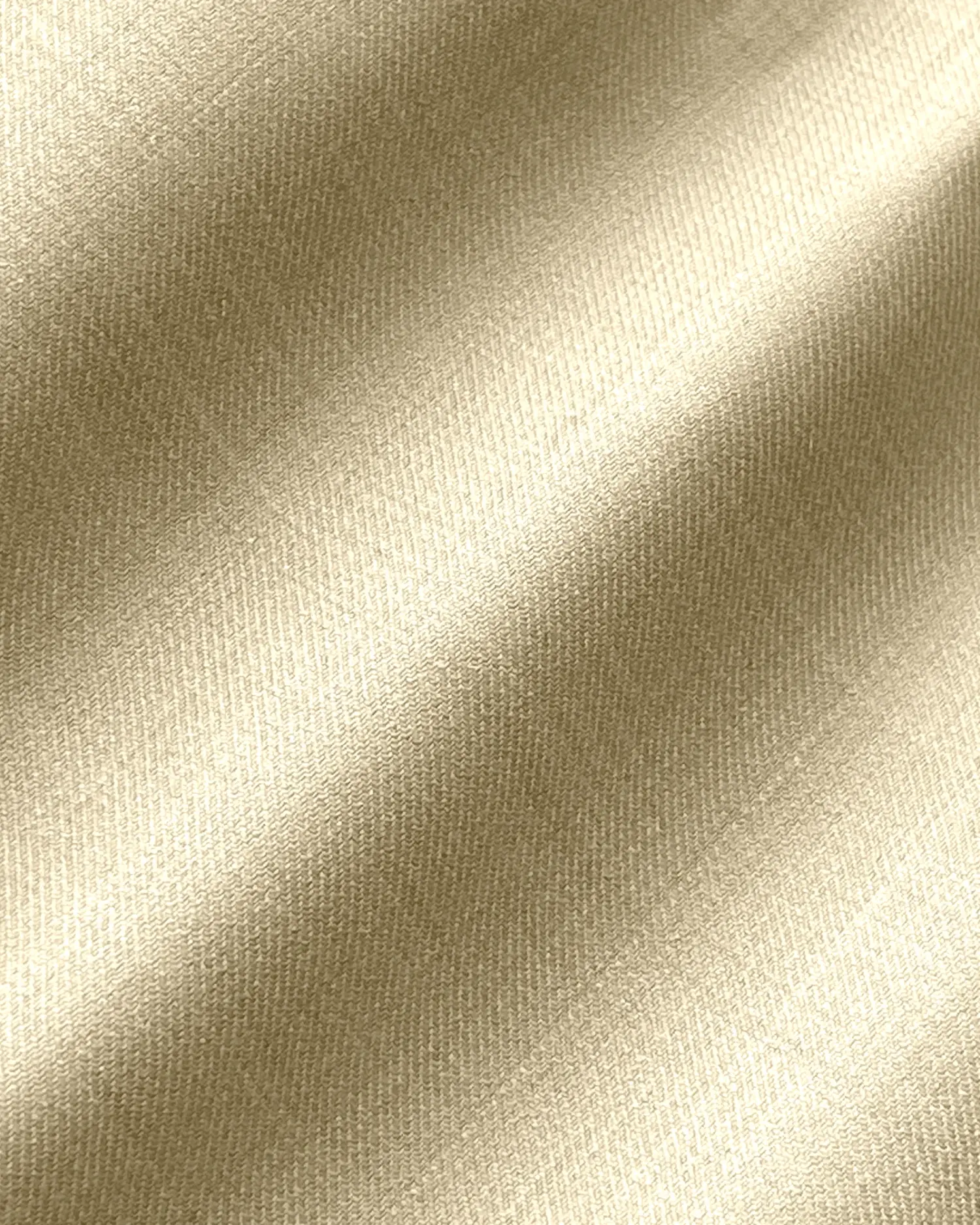 Close-up of luxurious gold satin fabric with a smooth, shiny texture and soft draping effect.