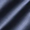 Close-up of textured blue fabric, showcasing a soft, diagonal weave with light and shadow effects.