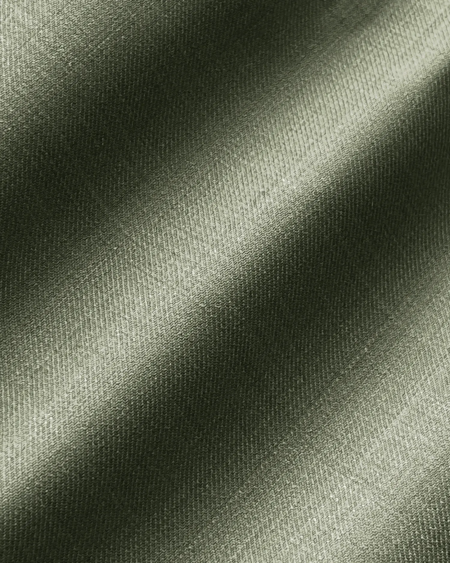 Close-up of textured olive green fabric with diagonal shadows and highlights.