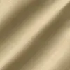 Close-up of smooth beige satin fabric texture with gentle folds.