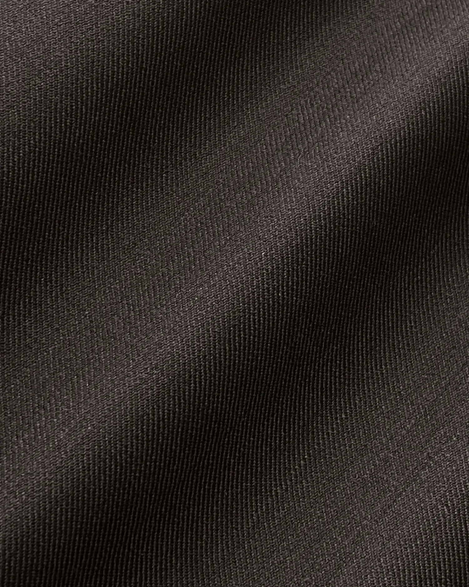 Close-up of black textured fabric with smooth ripples and high detail. Ideal for textiles or fashion context.