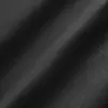 Close-up of smooth black fabric texture with soft shadows.