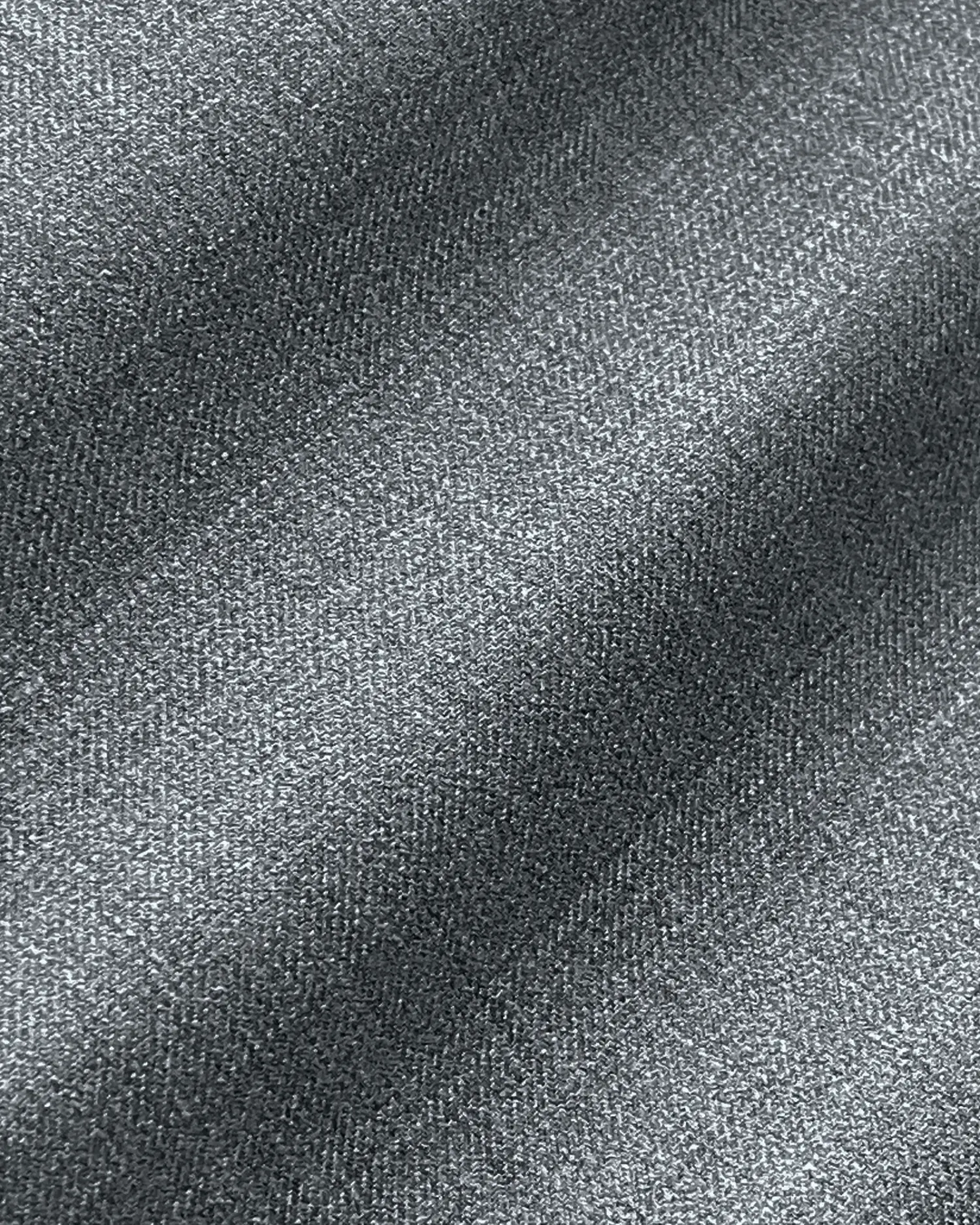 Close-up view of textured gray fabric with diagonal light and shadow patterns.