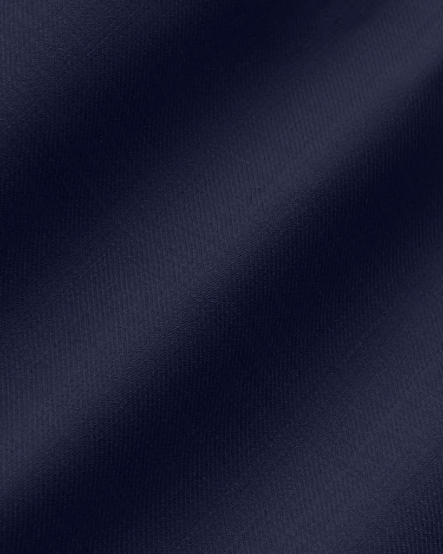 Dark blue textured fabric close-up, perfect for luxury clothing and textile design visuals.