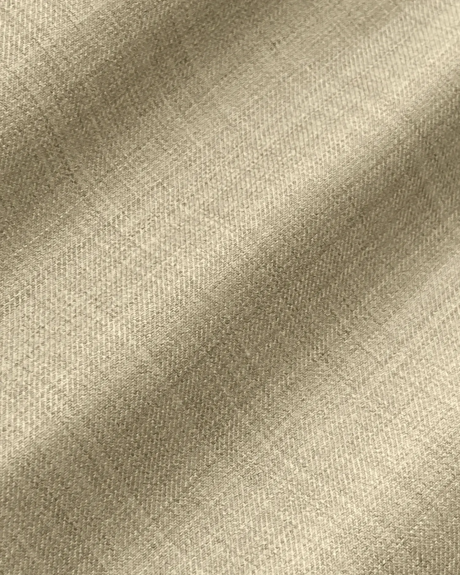 Beige textured fabric with subtle plaid pattern, showcasing soft and elegant textile material for fashion or upholstery.