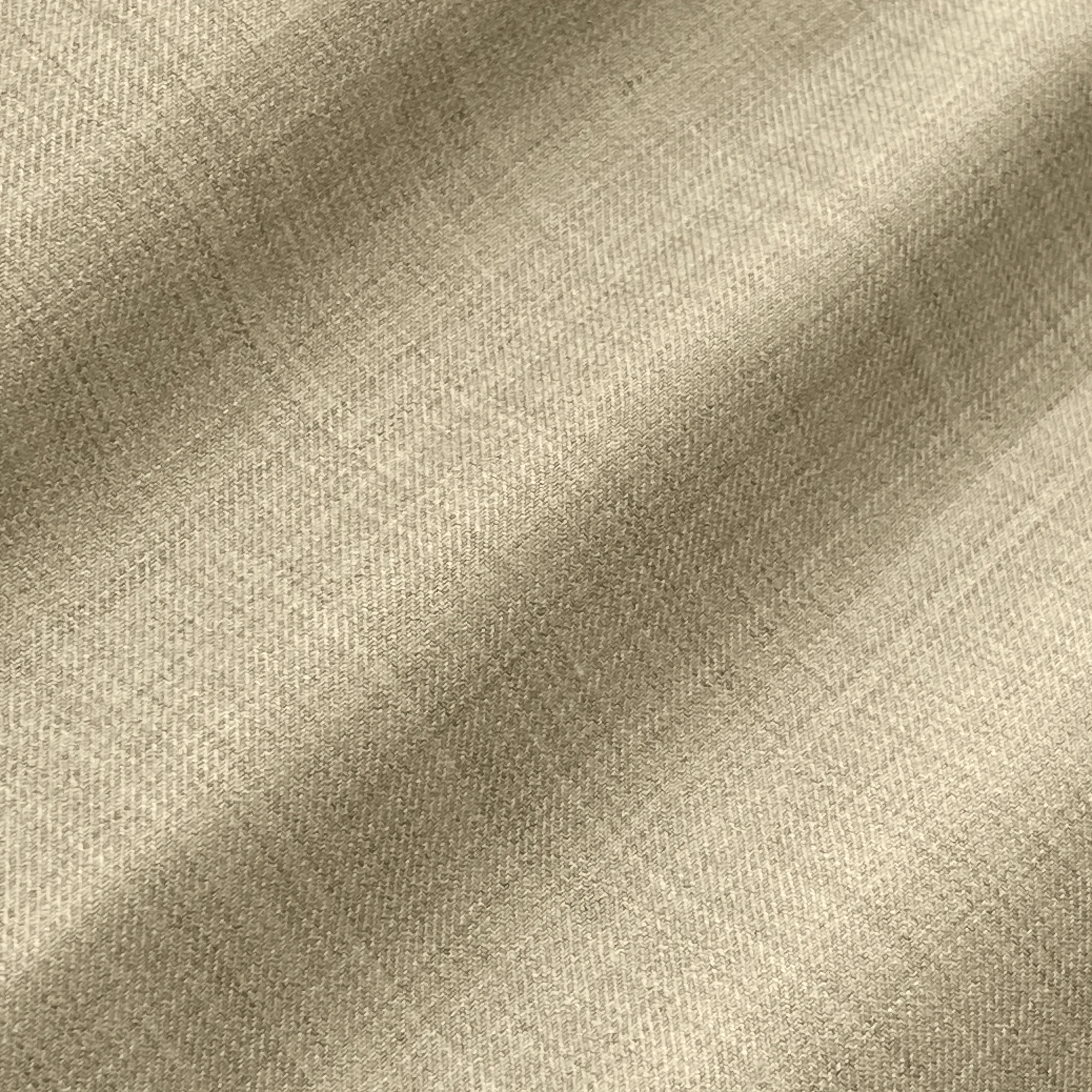 Beige textured fabric with subtle plaid pattern, showcasing soft and elegant textile material for fashion or upholstery.