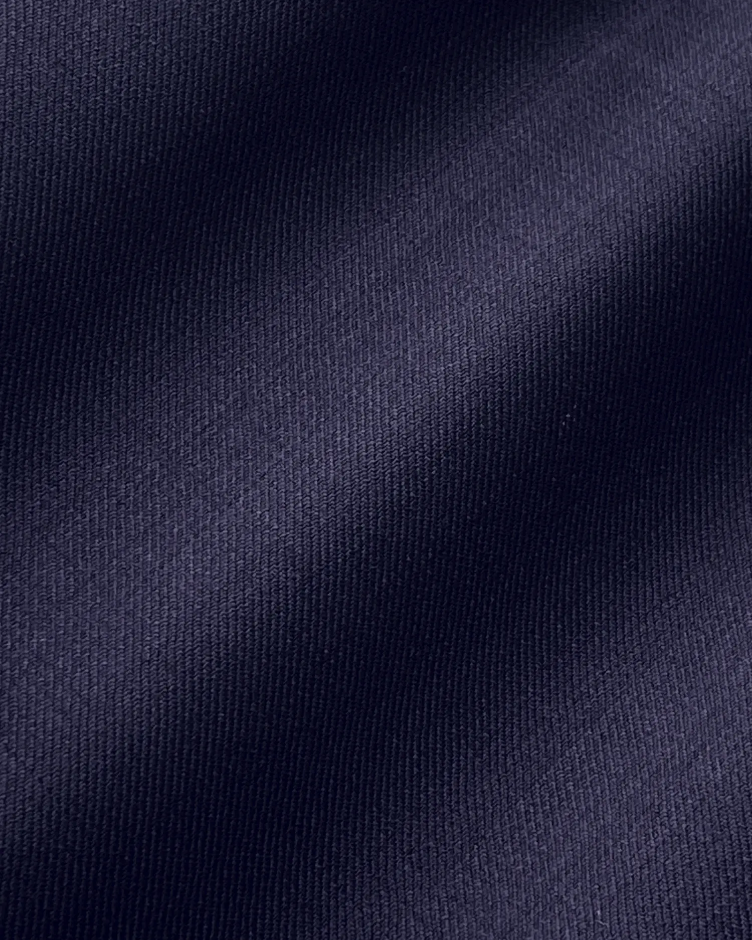Close-up of textured dark blue fabric with subtle diagonal shadowing.