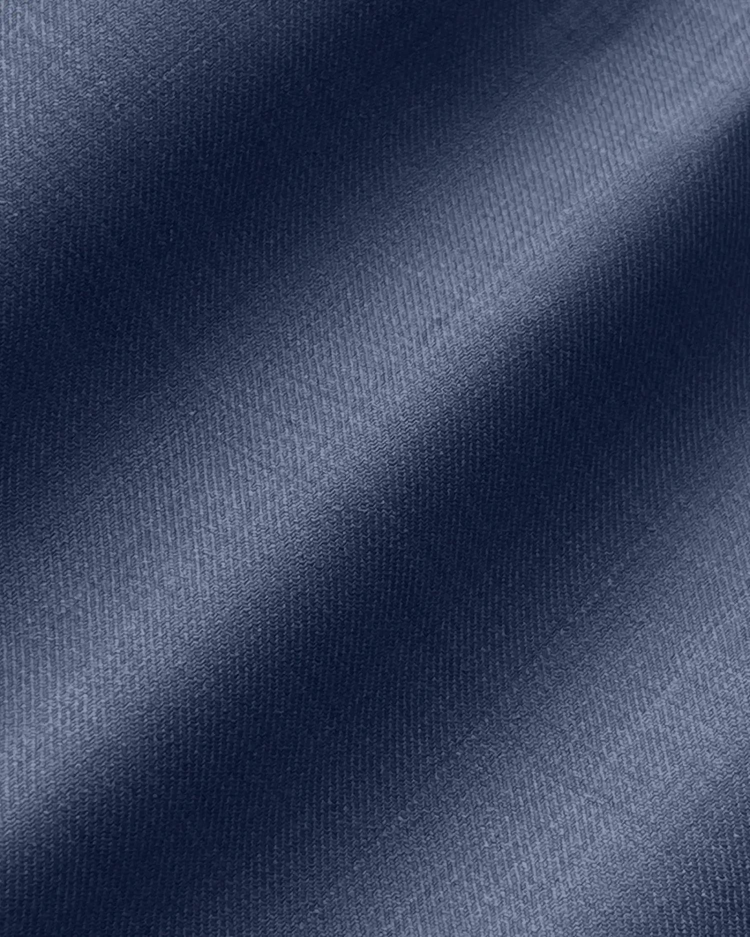 Close-up of smooth blue fabric texture, highlighting fine weave pattern and subtle color variations.
