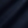 Dark blue textured fabric with subtle small dots creating a sleek, modern pattern.