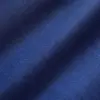 Close-up of blue herringbone fabric texture with diagonal zigzag pattern.