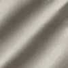 Close-up of a smooth, beige fabric with diagonal weave pattern, showcasing texture and material quality.