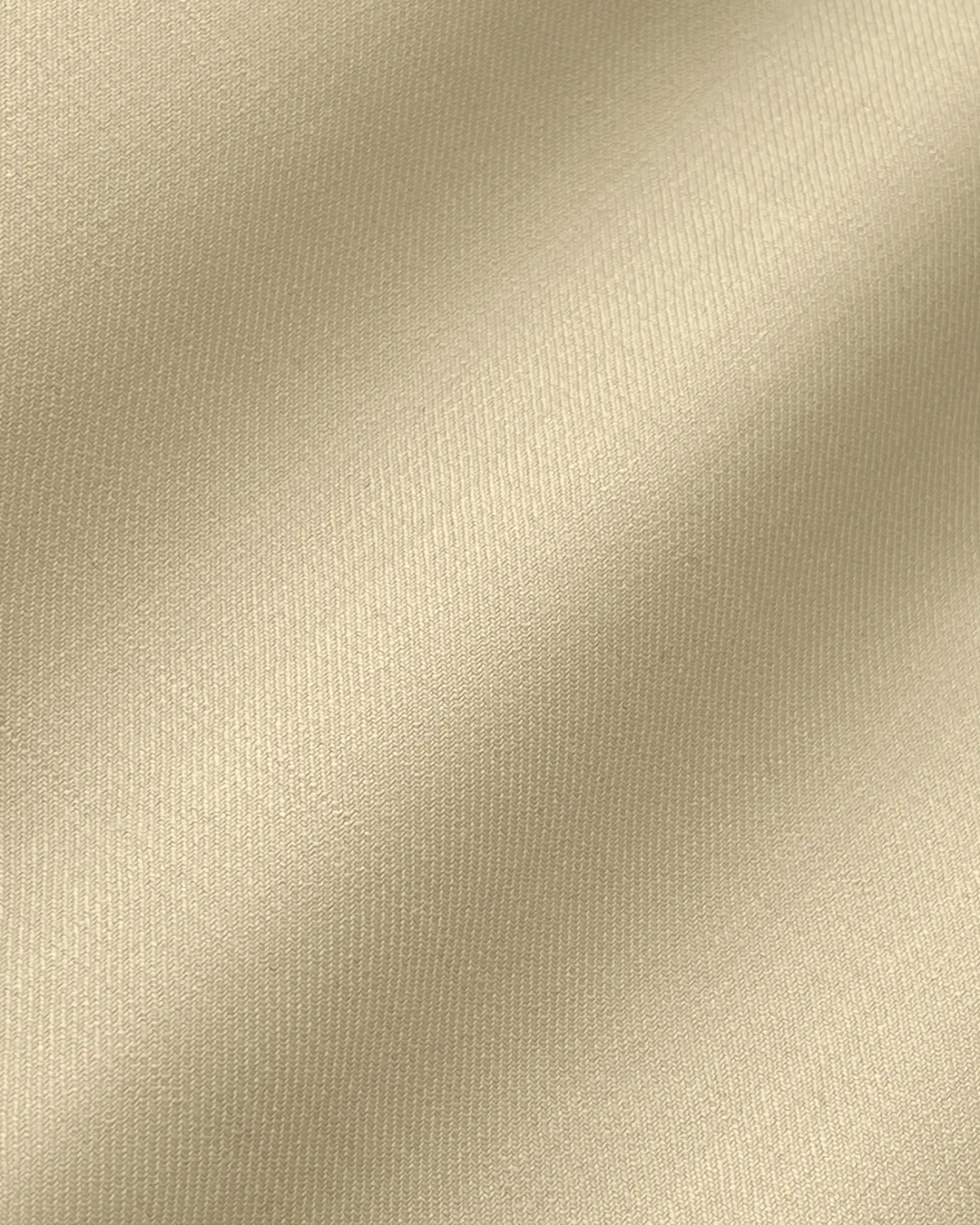 Smooth beige satin fabric texture with subtle light reflections. Ideal for luxury fashion and interior design inspiration.
