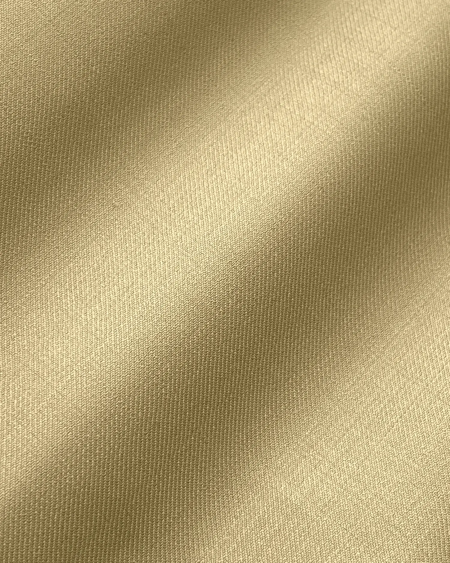 Smooth golden fabric with subtle waves, showcasing a luxurious satin texture and shimmer under soft lighting.