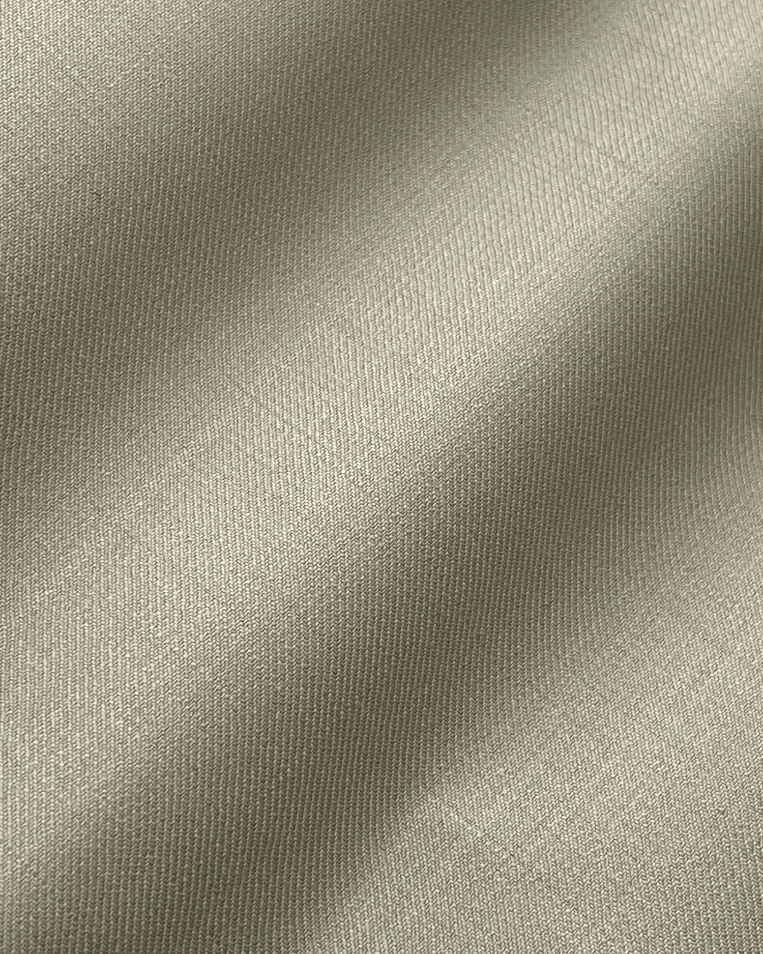 Close-up of textured gray fabric with soft lighting and elegant folds.