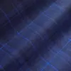 Blue plaid fabric with a classic checkered pattern, perfect for clothing or upholstery design.