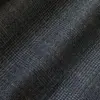 Close-up of dark gray plaid fabric with a subtle checkered pattern.