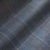 Close-up of a gray and blue plaid fabric pattern, perfect for winter fashion or upholstery design.