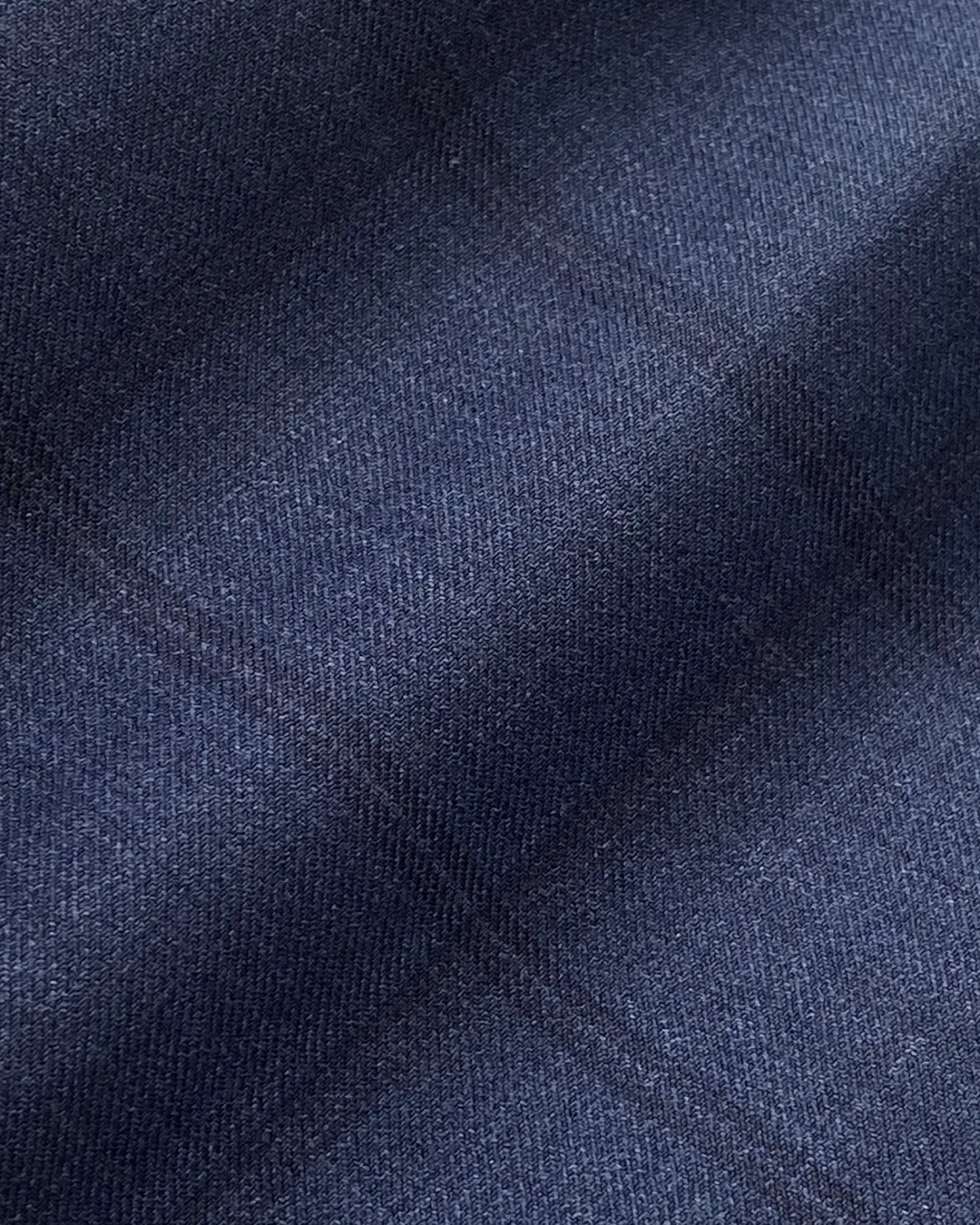 Close-up of dark blue plaid fabric texture with subtle intersecting lines.