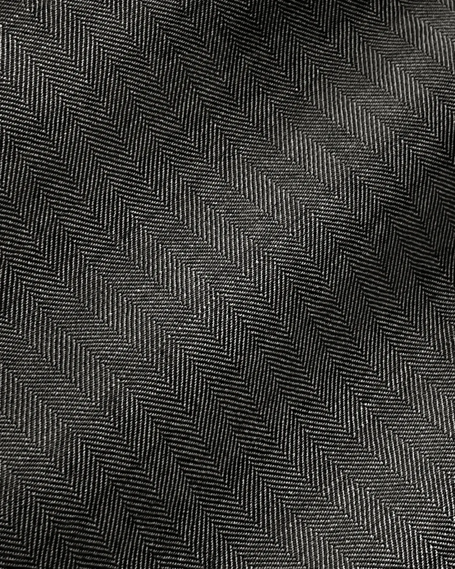 Black and gray herringbone fabric pattern, detailed close-up showing texture and design.