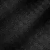 Close-up of black herringbone fabric texture with diagonal zigzag pattern, detailed textile surface.