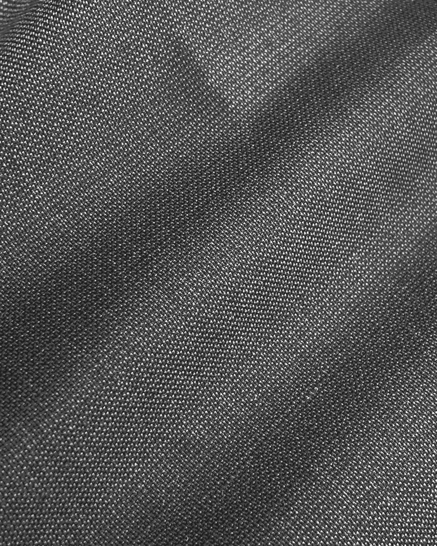 Close-up of smooth grey fabric texture, showing detailed weave patterns for textiles and fashion design.
