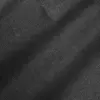 Close-up of black denim fabric with visible texture and weave.
