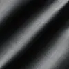 Close-up of black textured fabric with diagonal patterns and subtle shading.