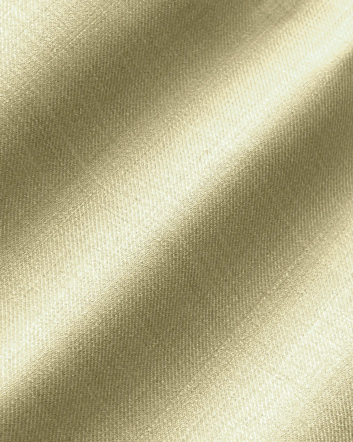 Close-up of luxurious beige fabric with a soft, shiny texture, casting subtle shadows. Perfect for elegant fashion designs.