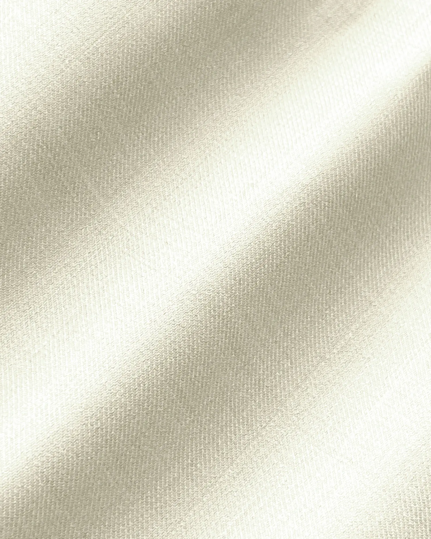 Smooth ivory silk texture with soft, shimmering folds, ideal for luxury fabric and textile design concepts.