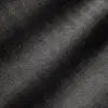 Close-up of dark herringbone patterned fabric with elegant texture and diagonal waves, highlighted by light and shadow.