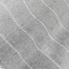 Close-up of a gray knitted fabric with a subtle wavy pattern, showcasing texture and craftsmanship.